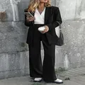 Full view of stylish black two-piece professional blazer and wide-leg trouser suit set. - S / Top And Bottom / Black
