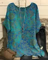 Detailed shot of bohemian loose blouse with vibrant mandala print and curved hem - S / Tops / Blue
