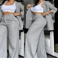 Detailed view of elegant women's grey two-piece blazer set and wide-leg trousers - S / Top And Bottom / Gray
