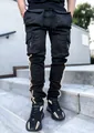 Detailed view of black reflective cargo pants with multiple pockets and elastic fabric. - M / Bottom (CK-838) / Black
