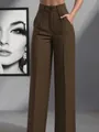 Detailed view of women's high-waisted brown straight-leg dress pants with pleats - S / Bottoms / Brown