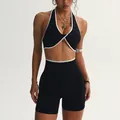 Completo yoga senza cuciture con bordo a contrasto e reggiseno incrociato nero - Taglia M / Parte Superiore e Parte Inferiore / Nero