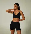 Seamless black yoga set featuring deep V sports bra and high-waisted shorts. - S / Top And Bottom / Black