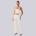 Zweiteiliges cremefarbenes Yoga-Set mit Neckholder-Top und Schlaghose mit hoher Taille - S / Oberteil Und Unterteil / Vanilleweiß