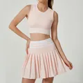 Conjunto deportivo rosa de dos piezas con top corto y falda de tenis plisada de talle alto - S / Top y Pantalón / Rosa Claro