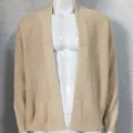 Detailed view of a beige waffle knit men's cardigan featuring an open front design - Beige