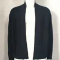 Close-up detail of black men's knit cardigan showing waffle texture and ribbed sleeve cuffs. - Black
