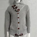Detailed view of grey cable-knit men's cardigan featuring unique toggle buttons and high neck - S / Tops / Gray