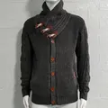 Detail view of men's chunky cable knit cardigan with toggle buttons and a high collar - Dark Gray