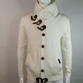 Close-up of men's cable knit cardigan featuring a high collar and toggle button details - S / Tops / White