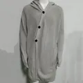 Detailed view of the grey knitted texture and black buttons of this long-line hoodie. - M / Tops / Light Gray