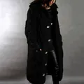 Close-up of a women's long chunky knit black cardigan with oversized light buttons. - Black