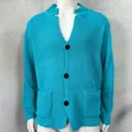Detailed view of a bright blue waffle-knit men's cardigan featuring three black buttons and pockets - S / Tops / Lake Blue