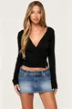 Fashion model wearing a black long-sleeved V-neck top paired with a denim mini skirt - S / Tops / Black