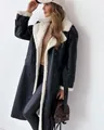 Detail of black faux leather coat featuring soft white shearling lining and wide lapels - S / Tops / Black