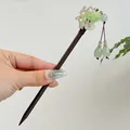 Close-up detail of a vintage Chinese style wooden hairpin with light green rose and tassels - Jade Linglong Style (FZ24375)