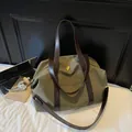 Vintage olive green canvas travel bag with large capacity and dark brown shoulder straps - Green