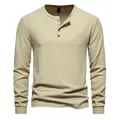 Close-up view of a men's long-sleeve waffle knit Henley shirt with four-button detail. - Khaki