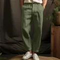 Detail view of men's olive green linen pants with a breathable straight leg design. - S / Bottoms / Green