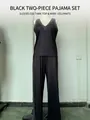 Dettaglio completo del set due pezzi nero con top scollo a V e pantaloni a gamba larga - XS / Top E Pantaloni / Nero