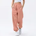 Detail of women high waisted peach joggers with elastic cuffs and convenient side pockets - Nude