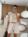 A stylish beige loungewear set featuring a padded shoulder top and matching shorts - S / Top And Bottom / Two-Piece Set / Apricot