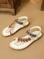Detailed shot of Bohemian ethnic flat sandals with intricate beading and heart accents - 38 / White