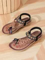 Detailed view of bohemian flat sandals with intricate beadwork and floral patterns - Light Black