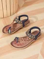 Detailed view of bohemian beach sandals featuring intricate beadwork and floral patterns. - Brown Blue