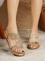 Detailed view of gold bohemian flat sandals with sparkling rhinestone flower patterns. - Gold
