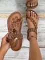 Close-up of Bohemian flat sandals with beaded straps and floral footbed pattern. - 35 / Dark Brown
