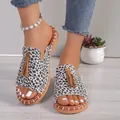 Close-up detail of dalmatian print peep-toe flat slippers with stylish tan tassels - 38 / White Leopard Print