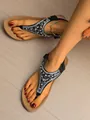 Close-up view of Bohemian black flat sandals with elegant pearl and rhinestone embellishments - 36 / Black