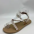 Close-up detail of white lace butterfly flat sandals with toe-loop for beach - 38 / White Floral