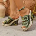 Detailed side view of camouflage denim wedge sandals featuring rustic metal buckles - 36 / Green