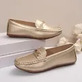 Close-up of gold slip-on loafers with metallic buckle and soft round toe design - 36 / Champagne Gold (Single Buckle Style)