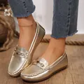 Close-up of gold textured flat loafers with metallic buckle and round toe design - 36 / Single Clasp Gold
