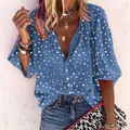 Close-up of blue polka dot V-neck blouse with buttons and long puffed sleeves - S / Tops / Blue