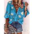 Detail view of a bohemian blue floral print blouse with button-up V-neck design - S / Tops / Blue