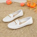 White perforated women's loafers featuring an elegant gold buckle on a flat sole - 36 / White