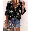 Detailed shot of women's black floral print blouse with V-neck and casual 3/4 sleeves. - S / Tops / Black