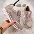 Detailed view of champagne wedge sneakers featuring rhinestone accents and side zipper closure. - 35 / Beige