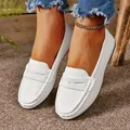 Close-up of elegant white leather flat loafers on a model for casual everyday wear - 36 / White