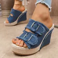 Detailed shot of blue denim wedge platform sandals with fringe edges and metal buckles. - 36 / Blue
