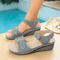 Detail view of grey vintage wedge platform sandals with decorative stitching on pool deck - 36 / Gray