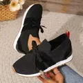 Close-up of black breathable knit sneakers with lace-up bow detail - 36 / Black