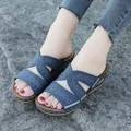 Detail view of blue embroidered wedge sandals with floral cutout patterns - 35 / Blue
