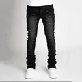 Detailed view of men's black stacked jeans featuring sparkling rhinestone studs - S(28) / Bottoms / Black