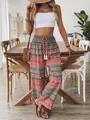 Model wearing Bohemian print high-waisted casual wide-leg pants in a sunlit interior - S / Bottoms / Pink