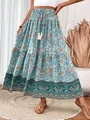 Detailed view of a bohemian blue floral maxi skirt with drawstring tassel waist details - S / Bottoms / Malachite green
